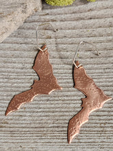 Load image into Gallery viewer, Copper bat earrings, textured cutout bat silhouettes on silver-tone hooks.