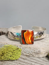 Load image into Gallery viewer, Silver glass bracelet with orange center panel and black swirl, diamond-pattern cuffs