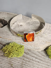 Load image into Gallery viewer, Orange and black glass bracelet on silver cuff, argyle diamond-pattern side panels