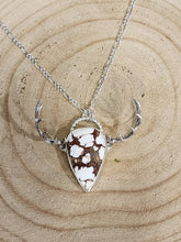 Load image into Gallery viewer, Silver-tone elk pendant necklace with antler-like side prongs and brown-white mottled inlay