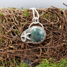 Load image into Gallery viewer, Sterling silver fish pendant featuring a round red-green gemstone cabochon
