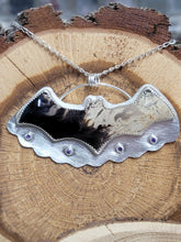 Load image into Gallery viewer, Silver bat-shaped pendant necklace with purple amethyst eyes, on wood slice