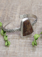 Load image into Gallery viewer, Silver-toned engraved cuff bracelet with triangular brown dinosaur-bone stone centerpiece