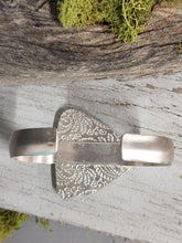 Load image into Gallery viewer, Silver cuff bracelet with etched texture and triangular backing panel beneath stone setting