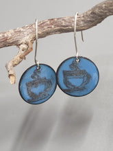 Load image into Gallery viewer, Blue enamel coffee cup disc earrings hanging from branch with silver hooks