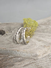 Load image into Gallery viewer, Silver zipper hoop stud earrings on log, two textured hoops with hinged backs