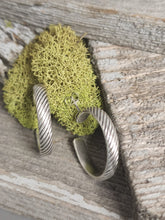 Load image into Gallery viewer, Silver rope-texture hoop earrings with small circular detail, close-up on clasp.