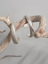 Load image into Gallery viewer, Silver rope-texture hoop earrings, front view of pair with inner hoop cutouts.