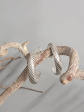 Load image into Gallery viewer, Silver rope-texture hoop earrings with curved open ends, visible stud back.