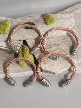 Load image into Gallery viewer, Four twisted copper cuff bracelets with braided bands and engraved silver charm beads