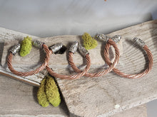 Load image into Gallery viewer, Twisted copper cuff bracelet with braided rope and silver patterned end beads
