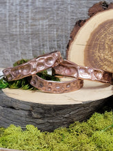 Load image into Gallery viewer, Copper textured bracelet, 1/2" wide, hammered finish with raised oval pattern.
